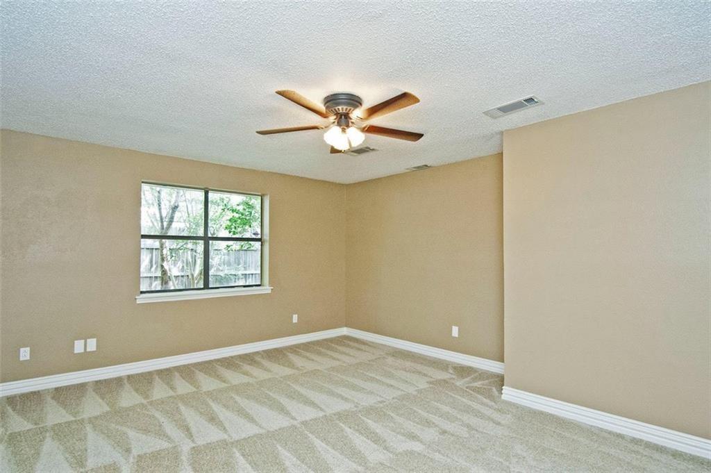 2509 Country Valley Road Garland, TX 75041 - Photo 10 of 17 Unfurnished room featuring a ceiling fan, light carpet, and a textured ceiling