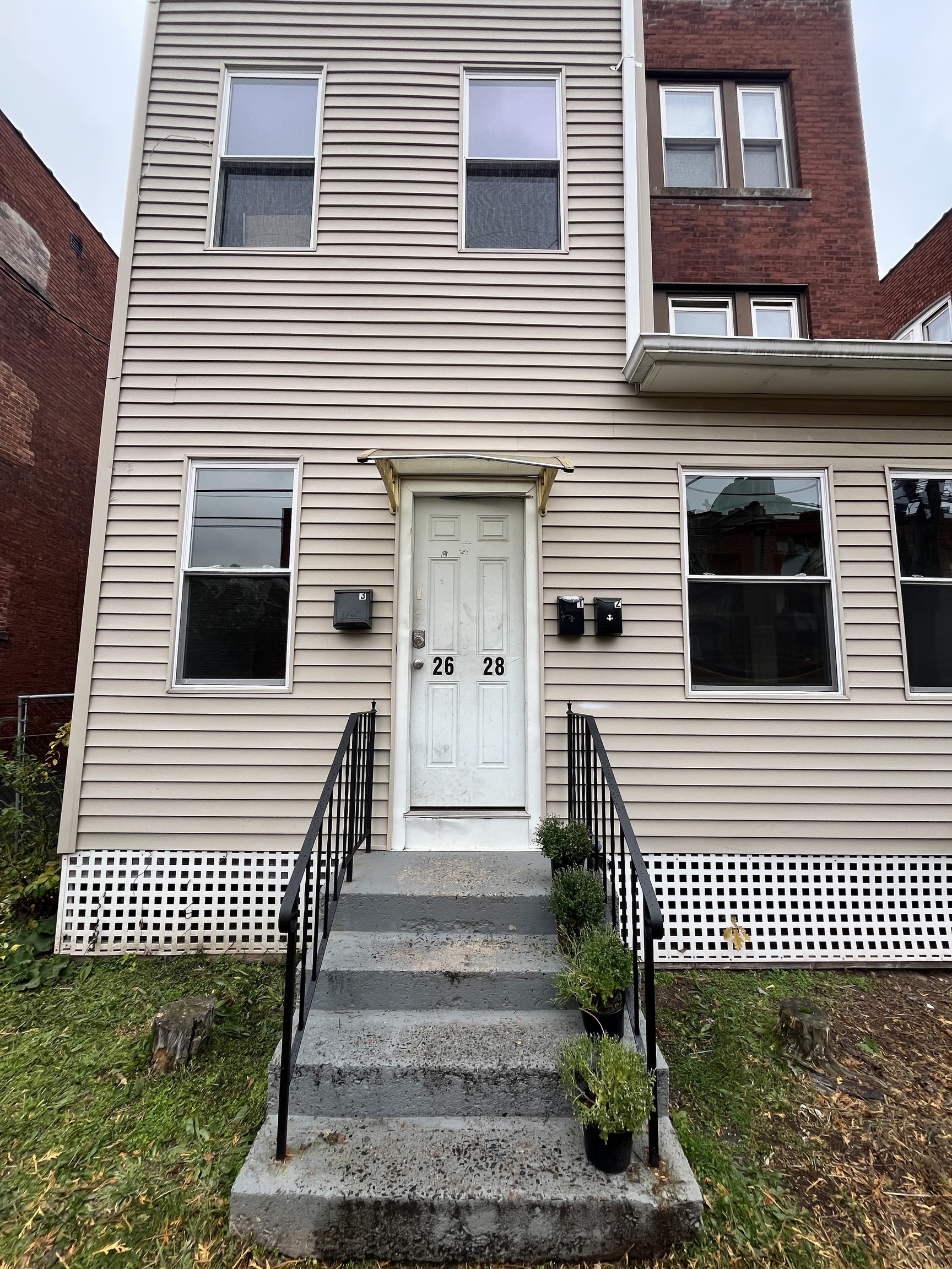a view of a brick house with stairs and wooden floor