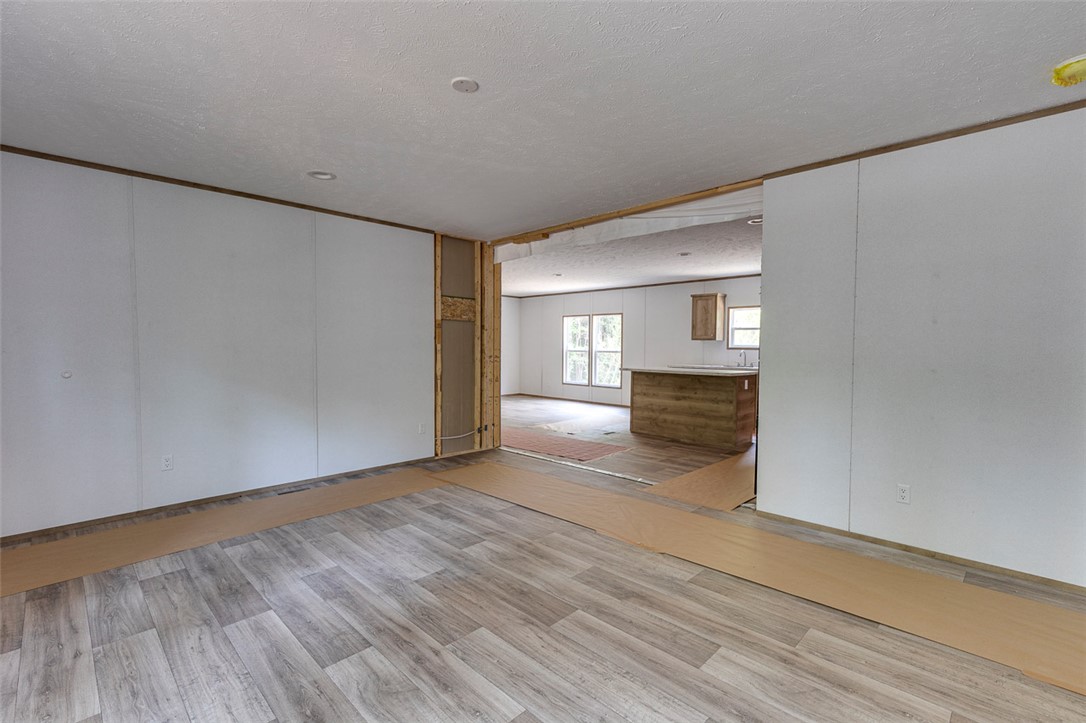 474 Bryant Road Pelzer, SC 29669 - Photo 17 of 42 Laminate flooring connects two bright, airy spaces with an open concept design, creating a seamless flow throughout.