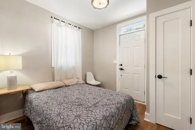 a bedroom with a bed and a wall painting