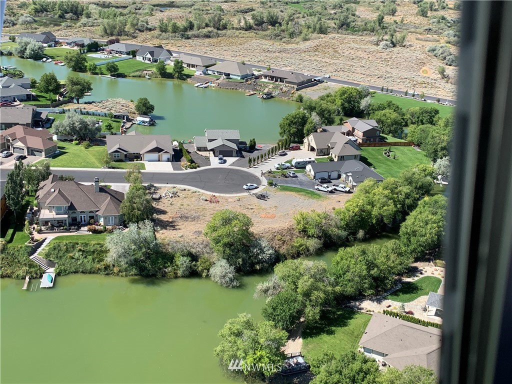an aerial view of lake houses and trees