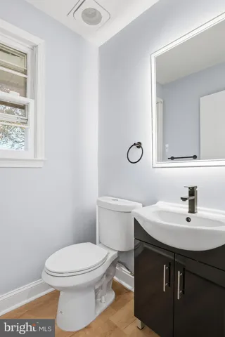 a bathroom with a sink a toilet and mirror