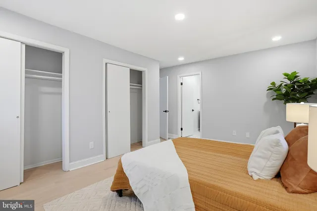 a bedroom with a bed and a potted plant