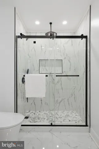 a bathroom with a shower and a toilet sink