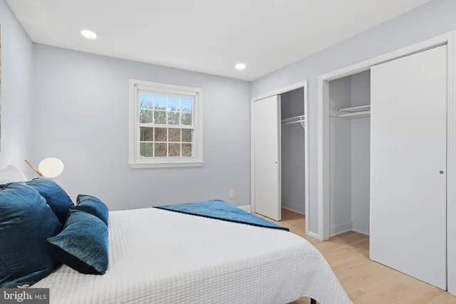 a bedroom with a large bed and a window