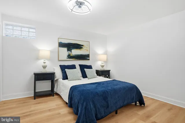 a bedroom with a bed and a painting on the wall