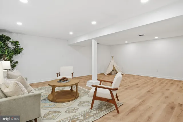 a living room with furniture and a potted plant