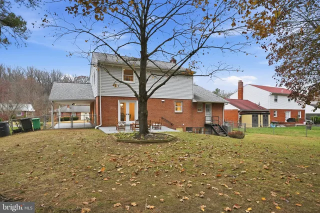a big house with large tree in front of it