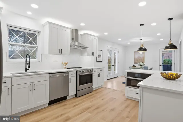 a kitchen with a sink stove and cabinets
