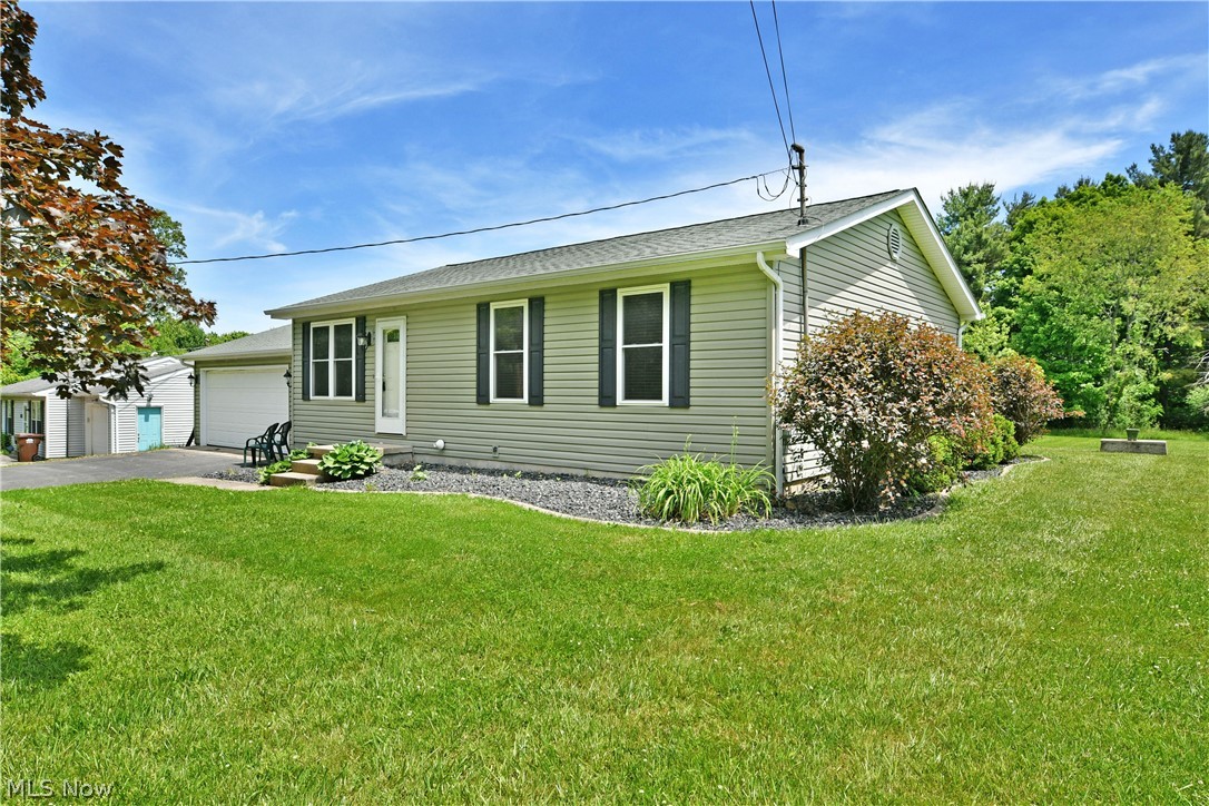 754 Warner Road Hubbard, OH 44425 - Photo 2 of 46 Light green siding exterior with dark shutters, featuring a prominent front entrance