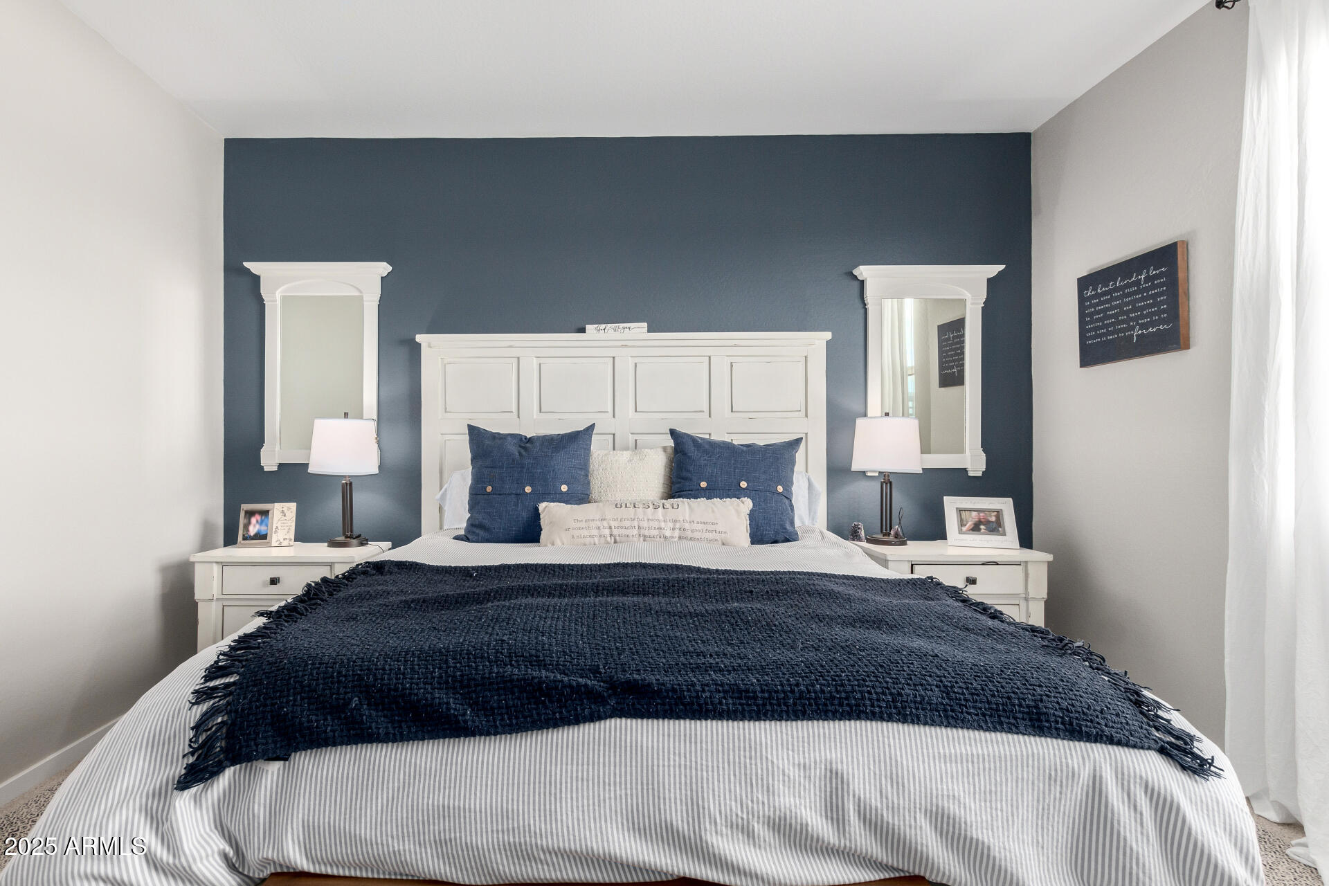 17454 West Red Fox Road Surprise, AZ 85387 - Photo 12 of 28 a bedroom with a bed a mirror and lamp