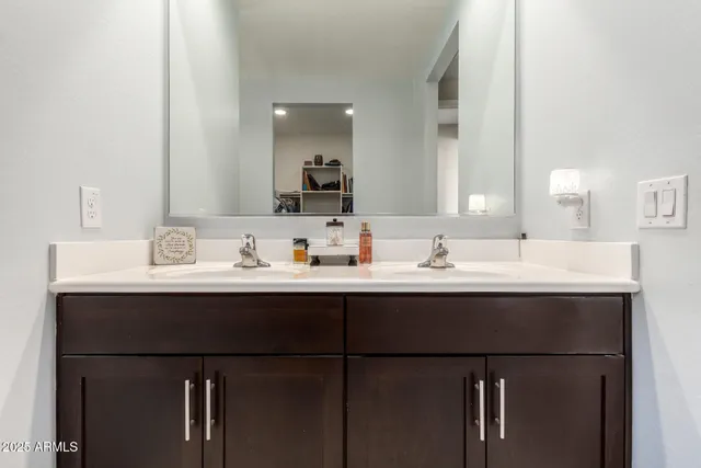 a bathroom with a sink and a mirror