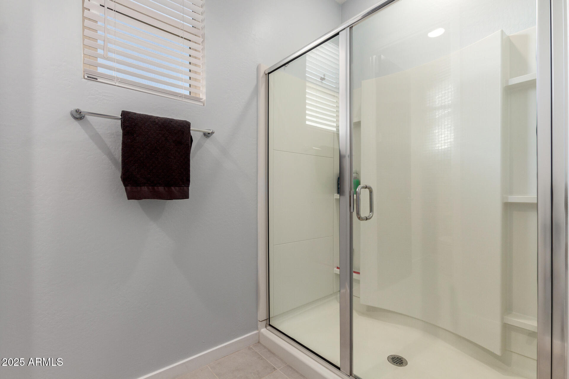 17454 West Red Fox Road Surprise, AZ 85387 - Photo 15 of 28 a bathroom with a shower and a sink