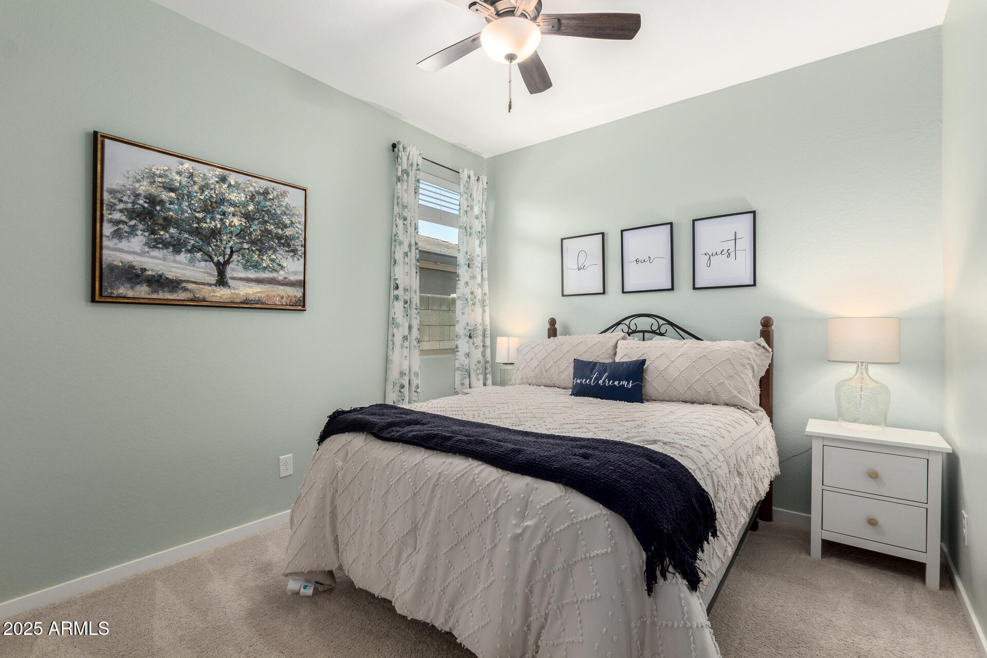 17454 West Red Fox Road Surprise, AZ 85387 - Photo 17 of 28 a bedroom with a bed and a chandelier