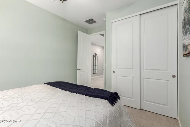 a bedroom with a bed and cabinets