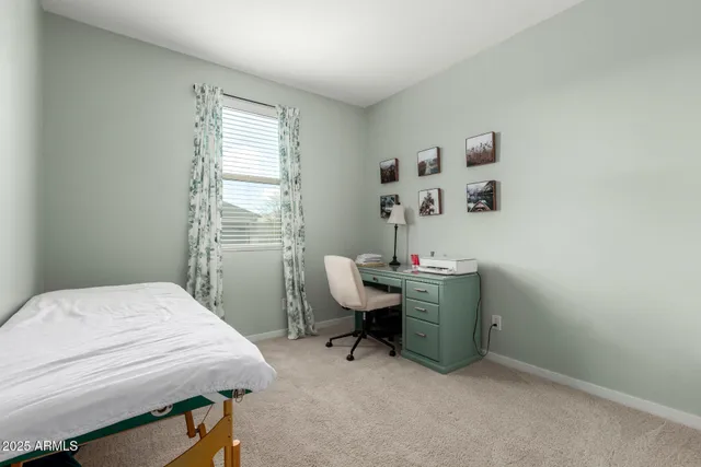 a room that has a bed and a desk in it