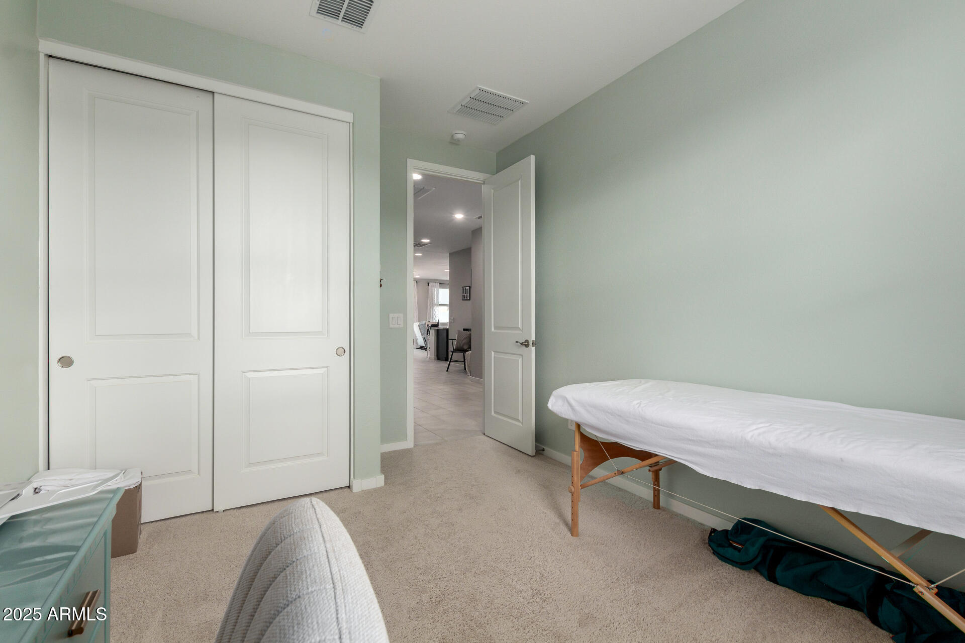 17454 West Red Fox Road Surprise, AZ 85387 - Photo 20 of 28 a room that has a bed and a table in it