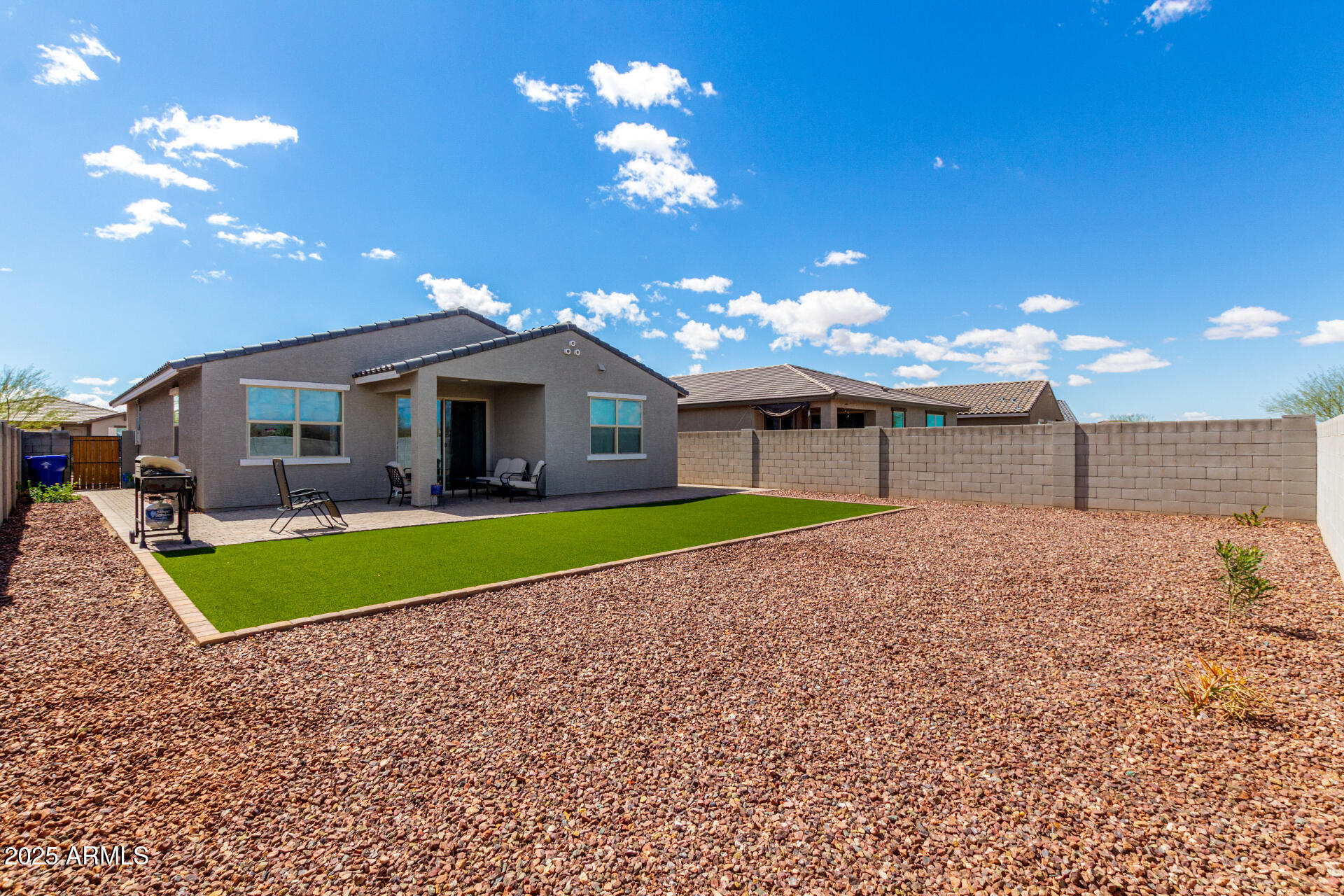 17454 West Red Fox Road Surprise, AZ 85387 - Photo 27 of 28 a front view of a house with a yard and garage