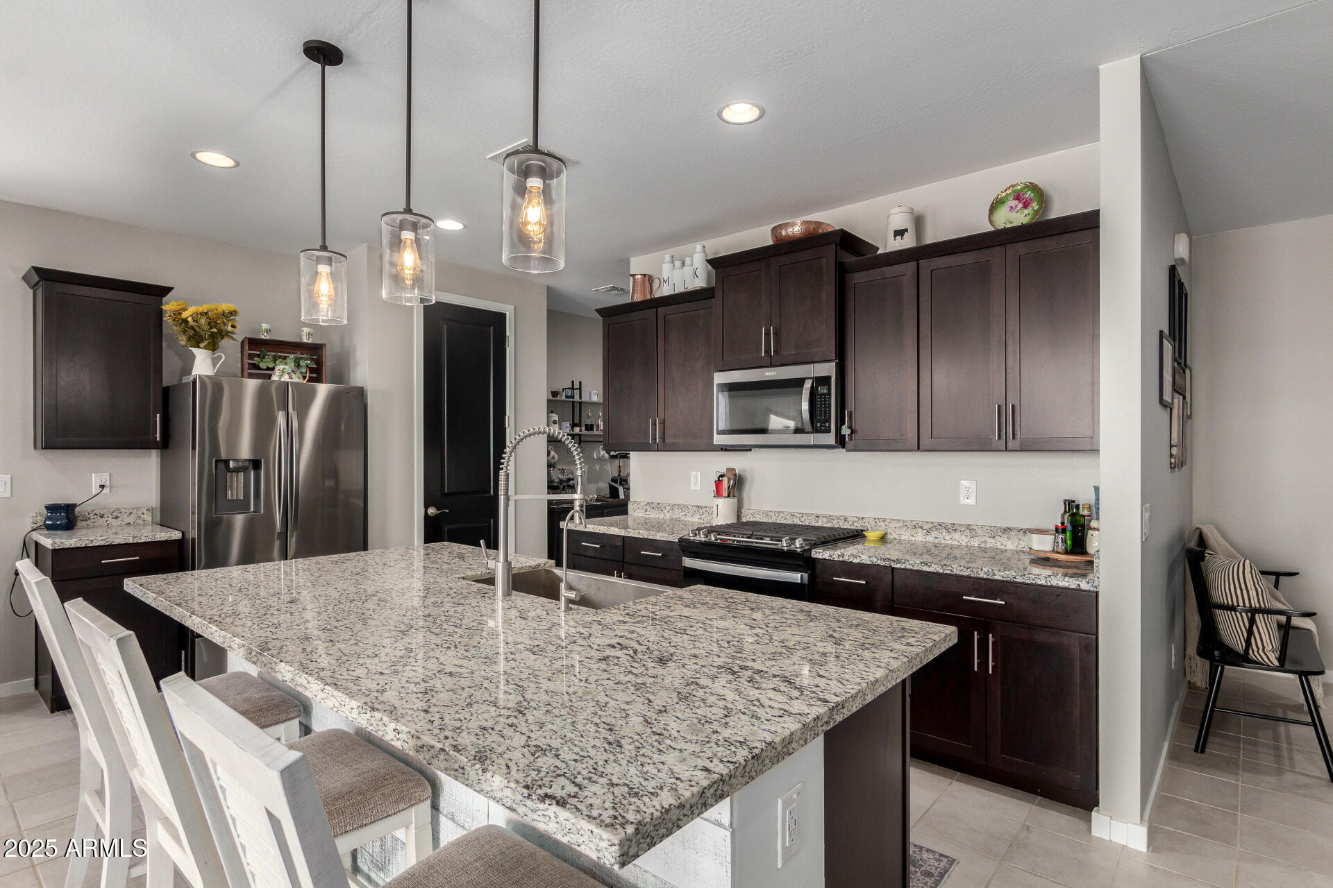 17454 West Red Fox Road Surprise, AZ 85387 - Photo 4 of 28 a kitchen with stainless steel appliances granite countertop a sink a stove and a refrigerator