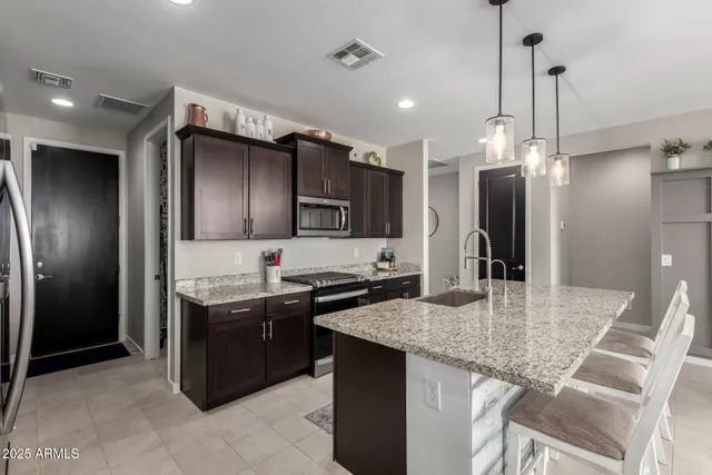 a kitchen with stainless steel appliances granite countertop a sink counter space and refrigerator