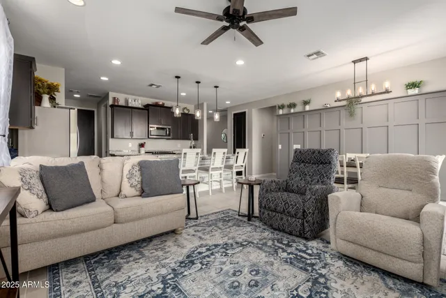 a living room with furniture and kitchen view