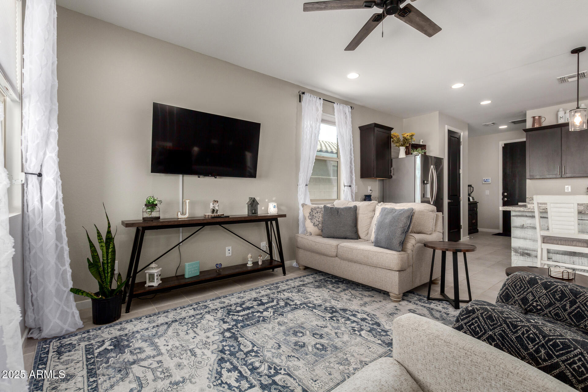 17454 West Red Fox Road Surprise, AZ 85387 - Photo 10 of 28 a living room with furniture and a flat screen tv