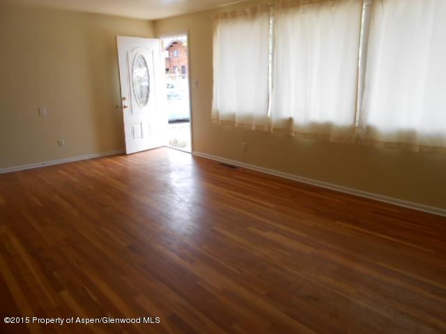 536 East 12th Street Rifle, CO 81650 - Photo 11 of 18 an empty room with wooden floor and windows