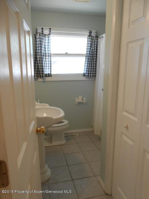 536 East 12th Street Rifle, CO 81650 - Photo 14 of 18 a bathroom with a sink a toilet and window