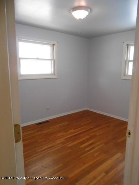536 East 12th Street Rifle, CO 81650 - Photo 15 of 18 an empty room with wooden floor and windows