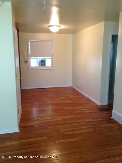 536 East 12th Street Rifle, CO 81650 - Photo 9 of 18 a view of an empty room with wooden floor and a window