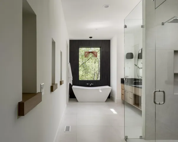 a bathroom with a granite countertop toilet sink and mirror