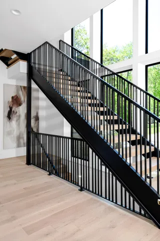 a view of a patio with table and chairs under an umbrella with a small yard
