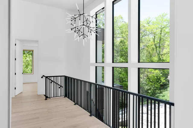 a view of a patio with couches table and chairs under an umbrella