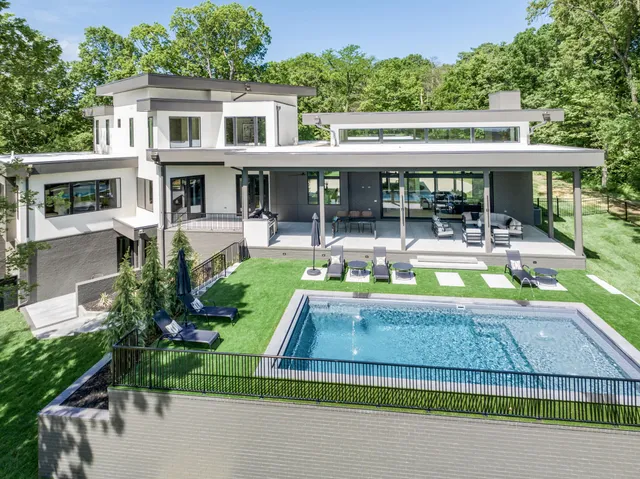 a living room with furniture and floor to ceiling windows