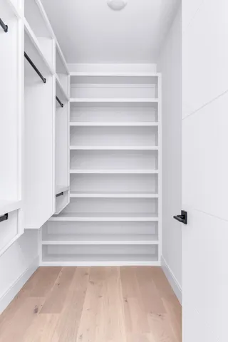 a front view of a house with a garden and trees