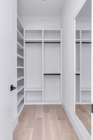 an aerial view of a house with a yard and a large tree