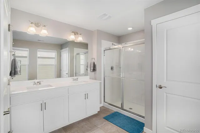 a bathroom with a double vanity sink mirror and double