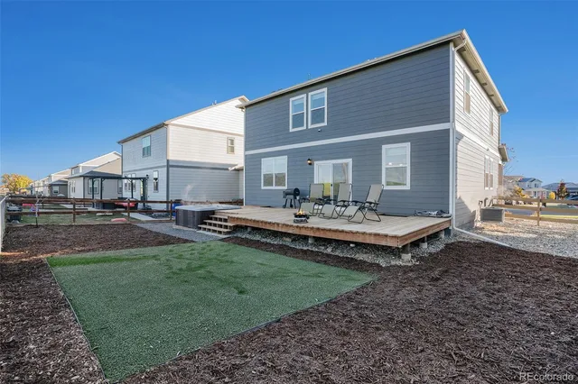 a front view of a house with swimming pool having outdoor seating
