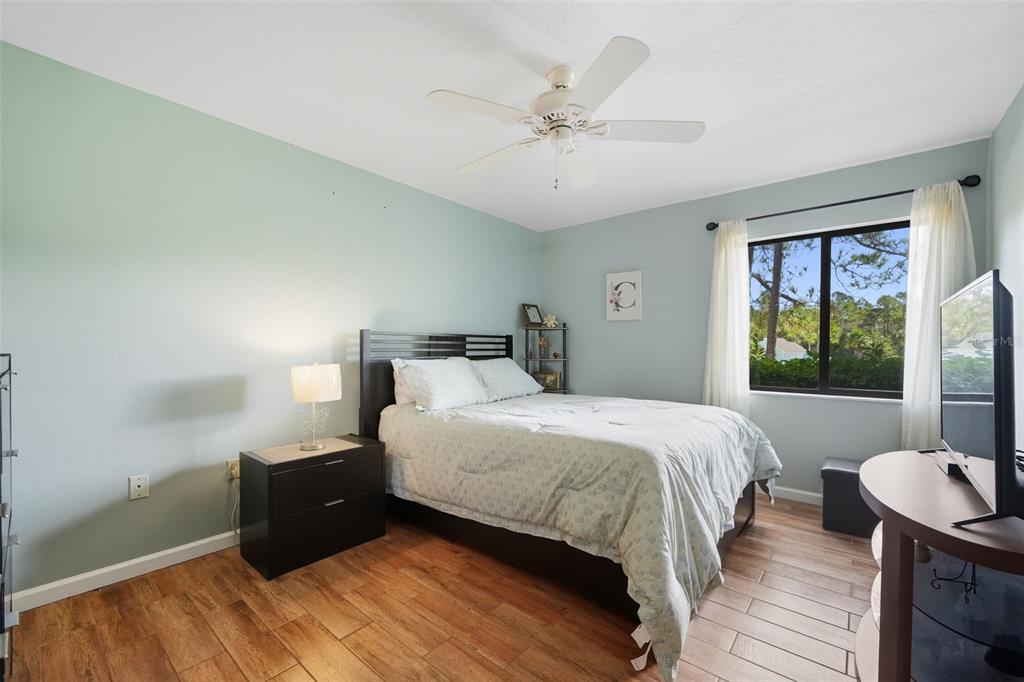 8174 Sturbridge Court, Unit 8174 Weeki Wachee, FL 34613 - Photo 16 of 32 a bedroom with a bed and a large window