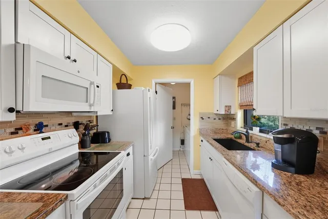 a kitchen with a sink stove and refrigerator