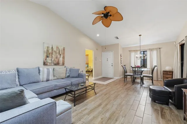 a living room with furniture and a chandelier
