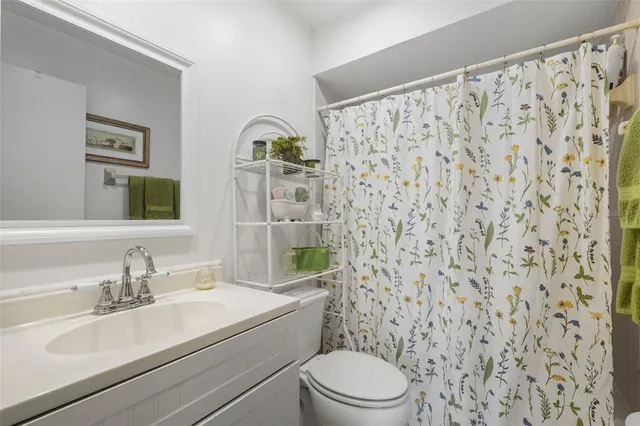 a bathroom with a toilet a sink and a mirror