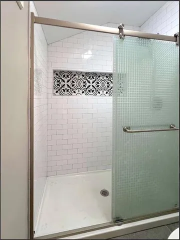 a bathroom with a shower and a sink