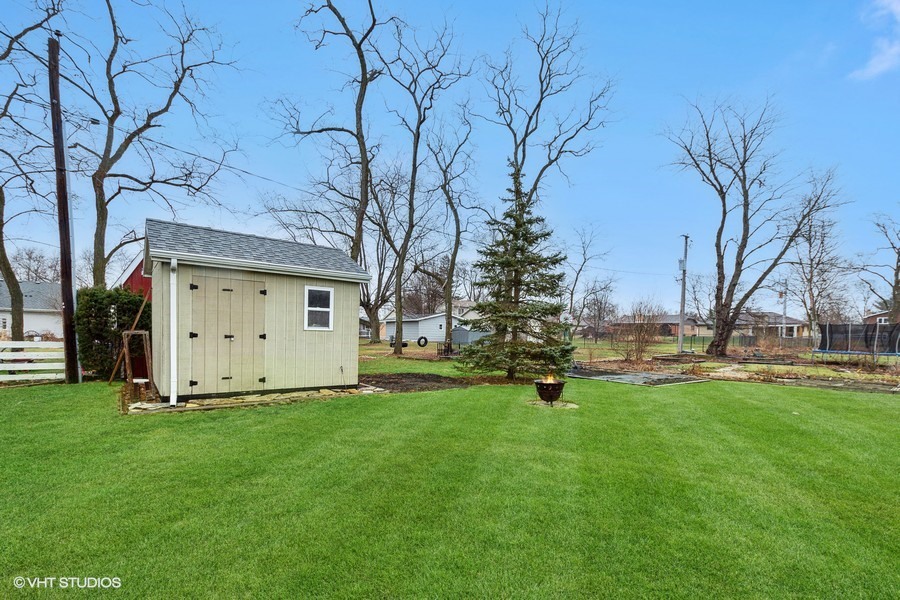 11034 Bryant Road Mokena, IL 60448 - Photo 18 of 19 a view of a backyard with large trees