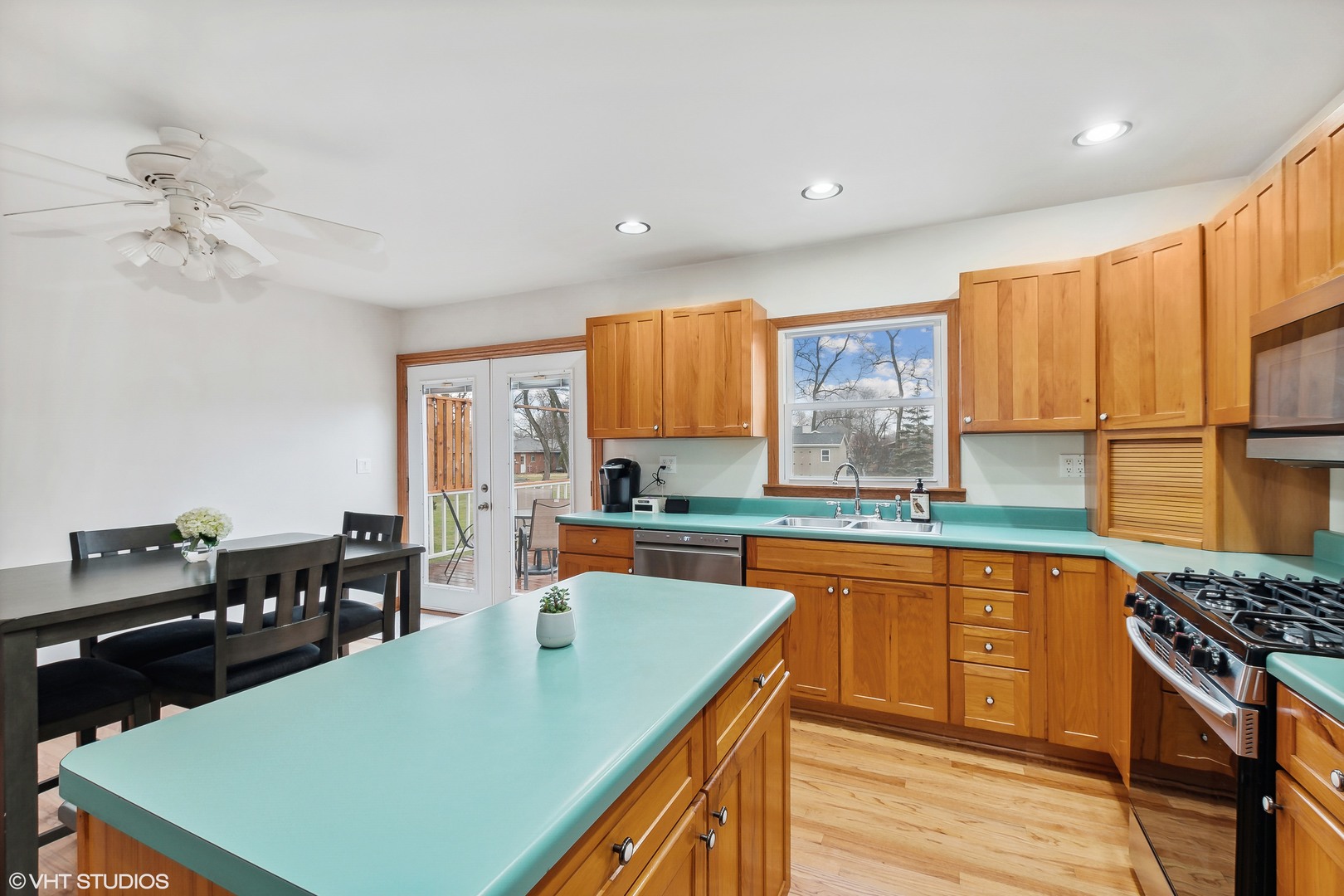 11034 Bryant Road Mokena, IL 60448 - Photo 5 of 19 a kitchen with stainless steel appliances granite countertop a stove top oven a sink dishwasher and cabinets with wooden floor