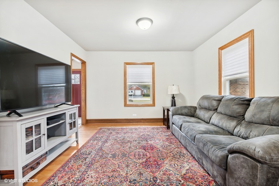 11034 Bryant Road Mokena, IL 60448 - Photo 8 of 19 a living room with furniture and a flat screen tv