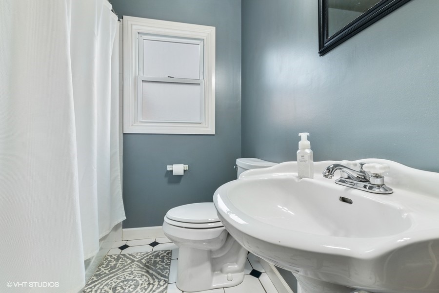 11034 Bryant Road Mokena, IL 60448 - Photo 9 of 19 a bathroom with a sink a toilet and mirror