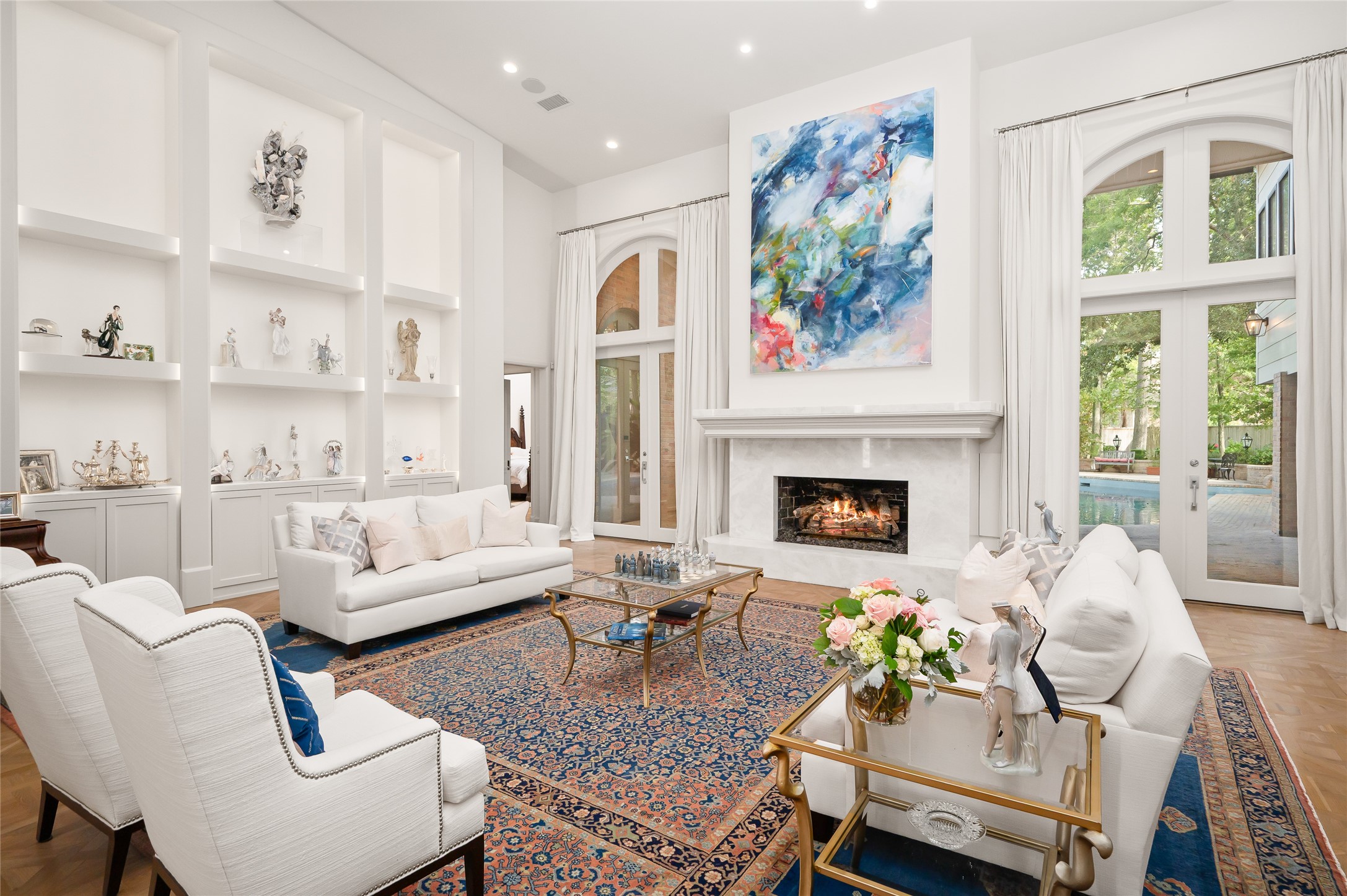 11518 Shadow Way Street Houston, TX 77024 - Photo 5 of 50 The Great Room/ Formal Living Room anchors the seamless flow of the downstairs, featuring soaring ceilings, French doors, with access to the backyard, primary suite, formal dining room, and kitchen.