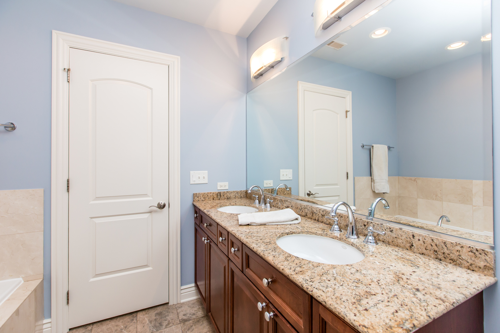 35 South Racine Avenue, Unit 4SE Chicago, IL 60607 - Photo 12 of 24 a bathroom with a granite countertop sink and a mirror