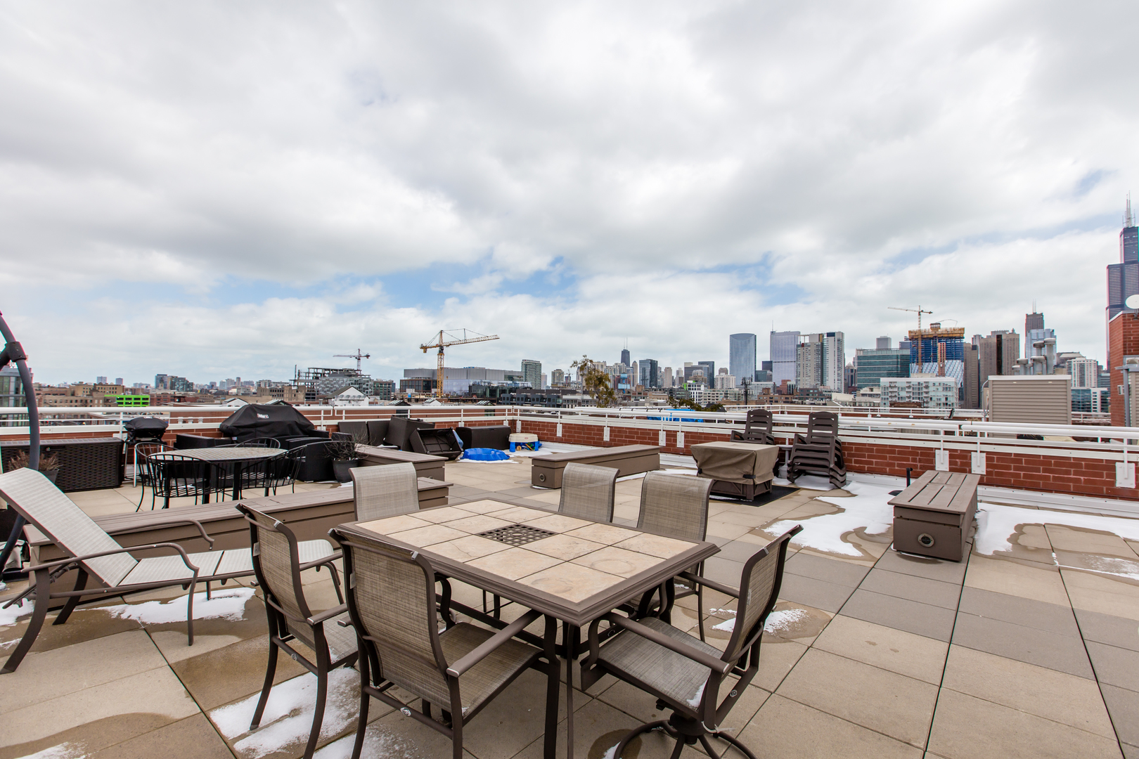 35 South Racine Avenue, Unit 4SE Chicago, IL 60607 - Photo 23 of 24 a terrace with outdoor seating city view and barbeque oven
